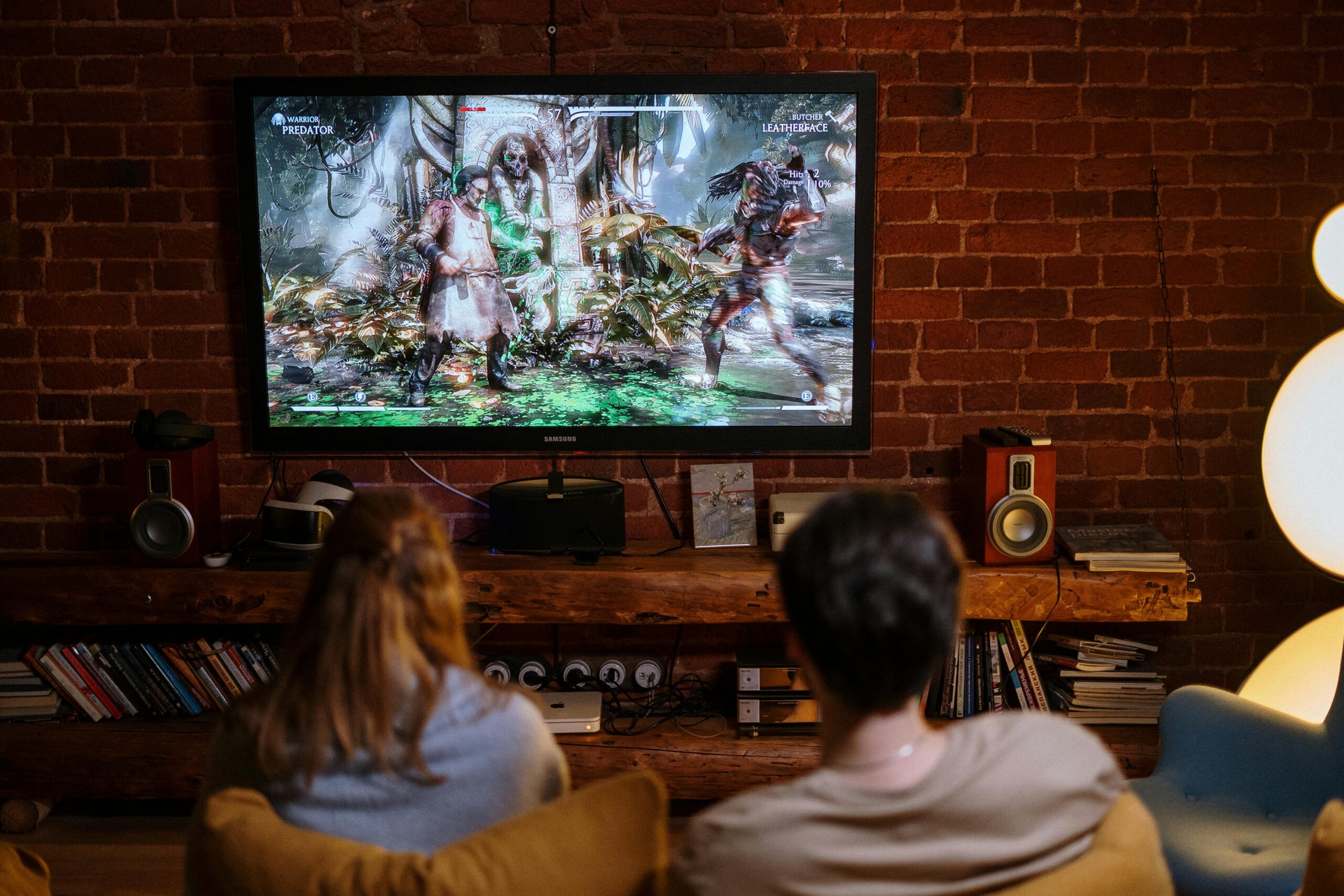 A couple enjoys playing video games on a cozy evening at home.